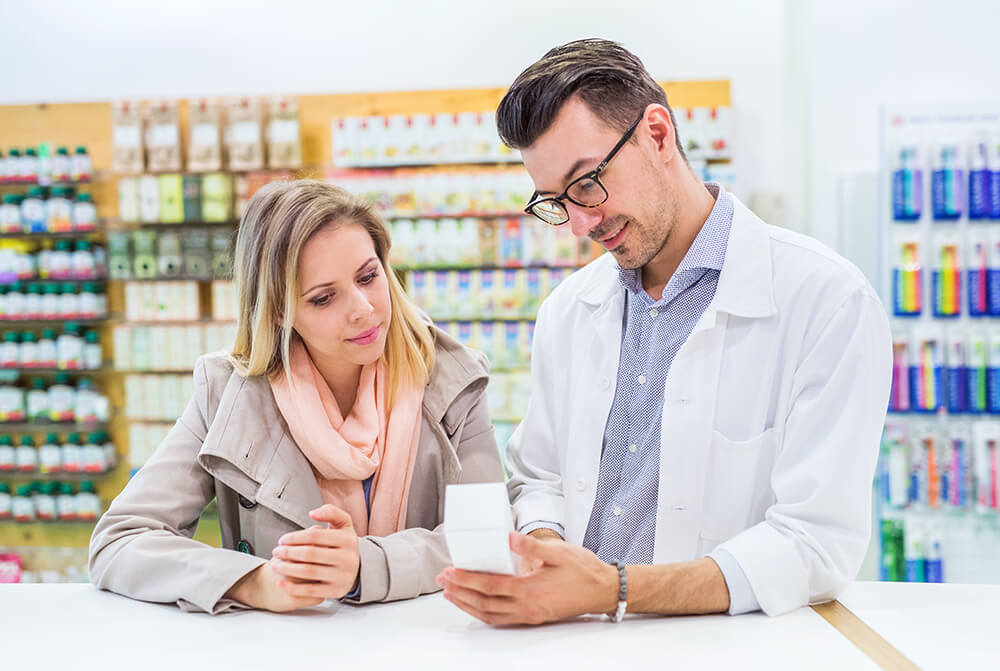 male-pharmacist-serving-a-female-customer-PS4L67K.jpg